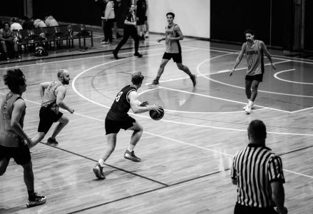 Players bringing the ball up the court